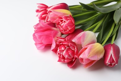 Photo of Beautiful tulips on white background, closeup. Space for text