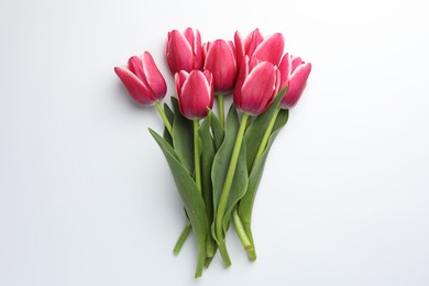 Photo of Beautiful tulips on white background, flat lay