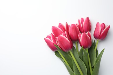 Photo of Beautiful tulips on white background, flat lay. Space for text
