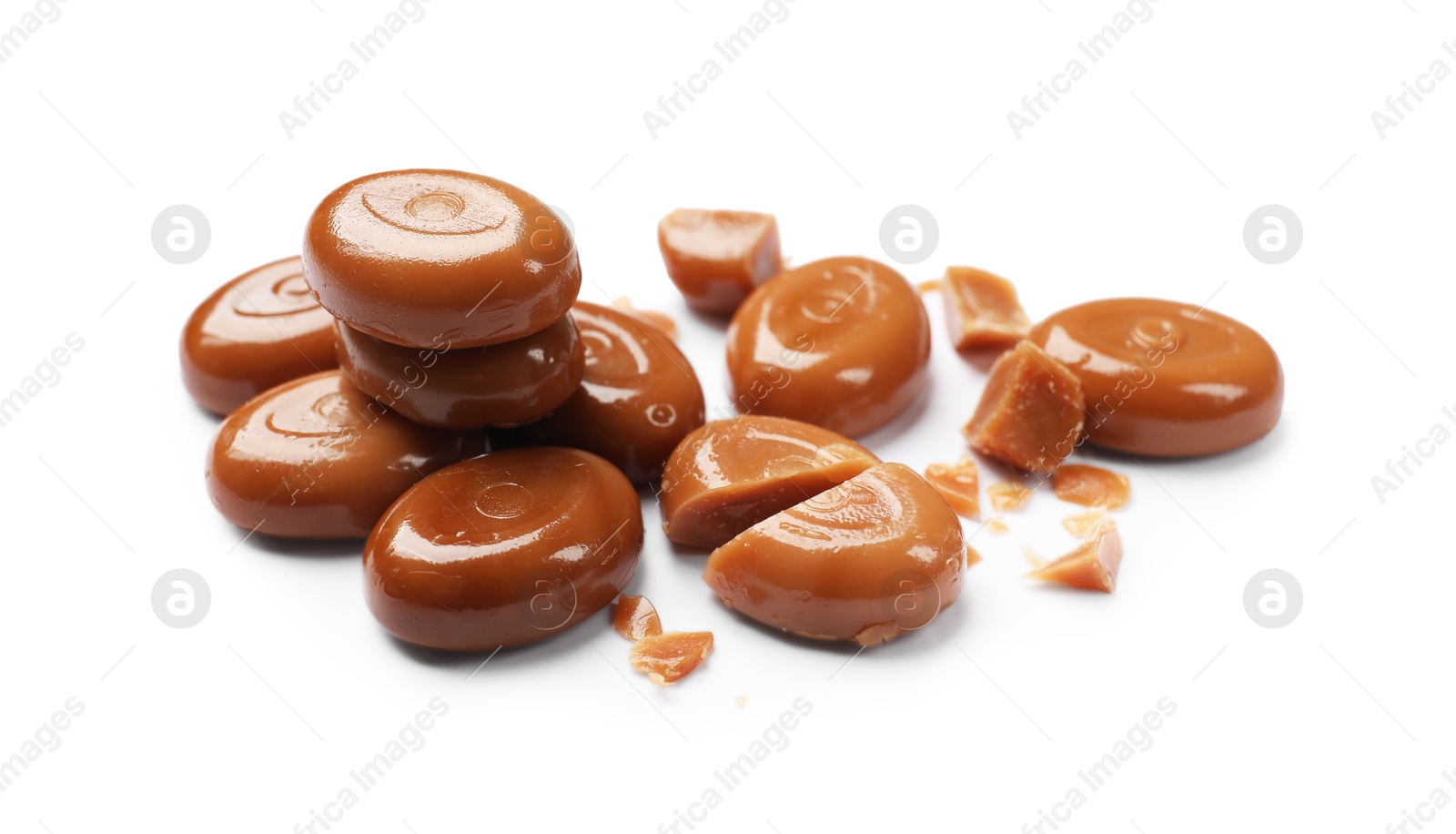 Broken tasty caramel candies isolated on white Photo of Broken tasty caramel candies isolated on white