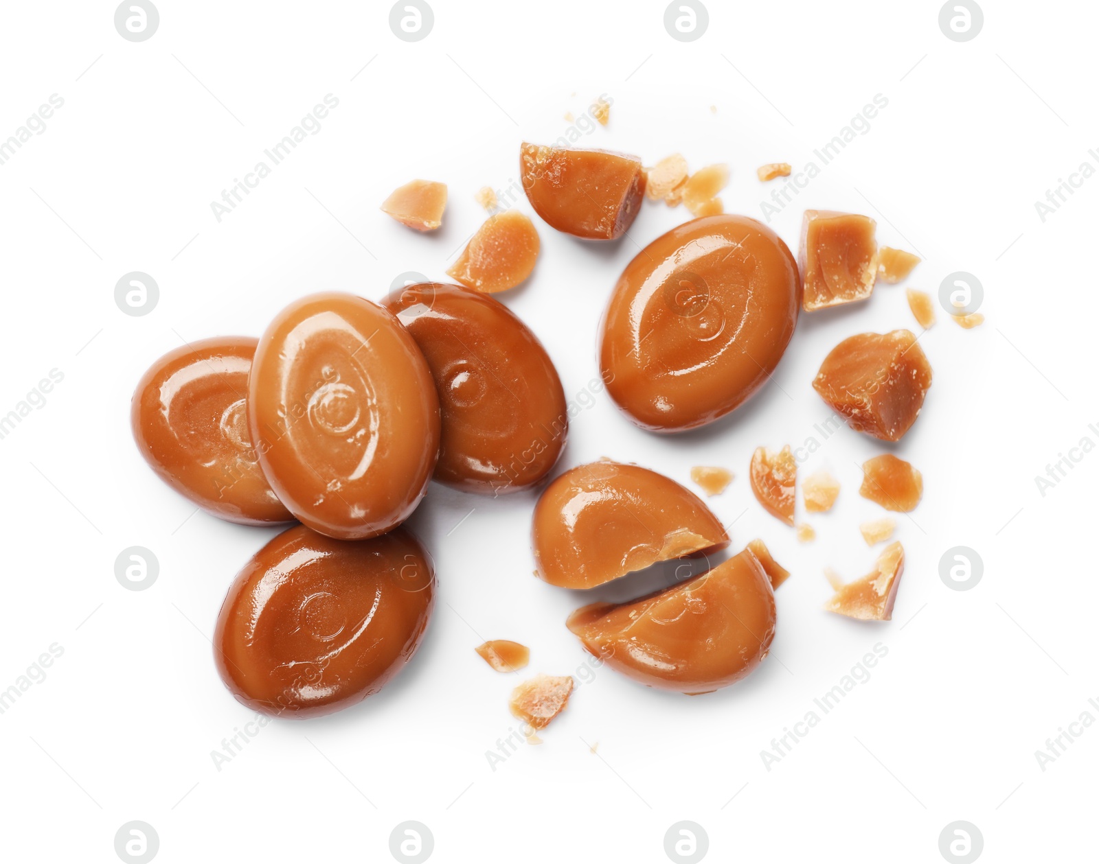 Photo of Broken tasty caramel candies isolated on white, top view