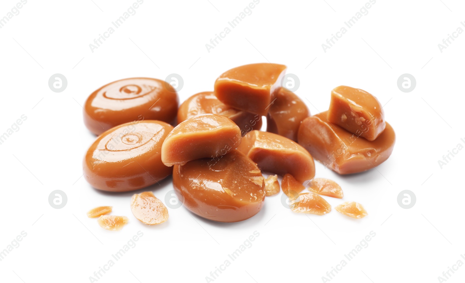 Broken tasty caramel candies isolated on white Photo of Broken tasty caramel candies isolated on white