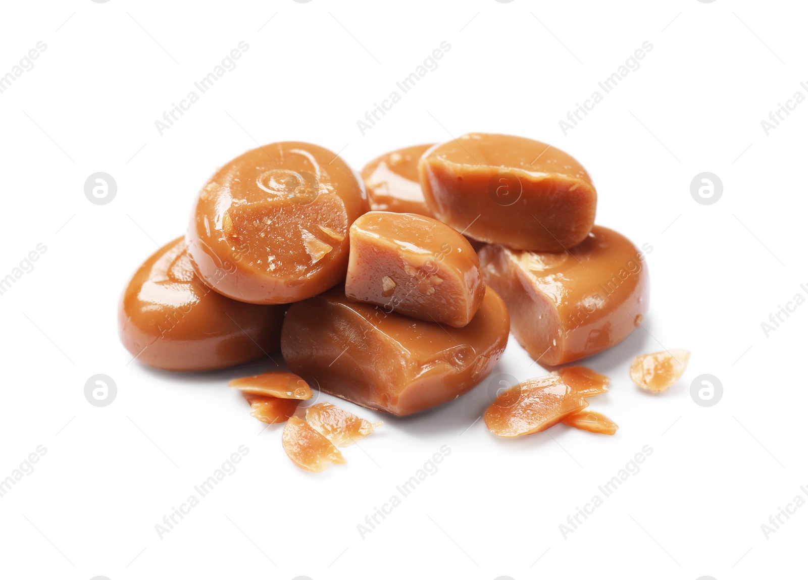 Broken tasty caramel candies isolated on white Photo of Broken tasty caramel candies isolated on white