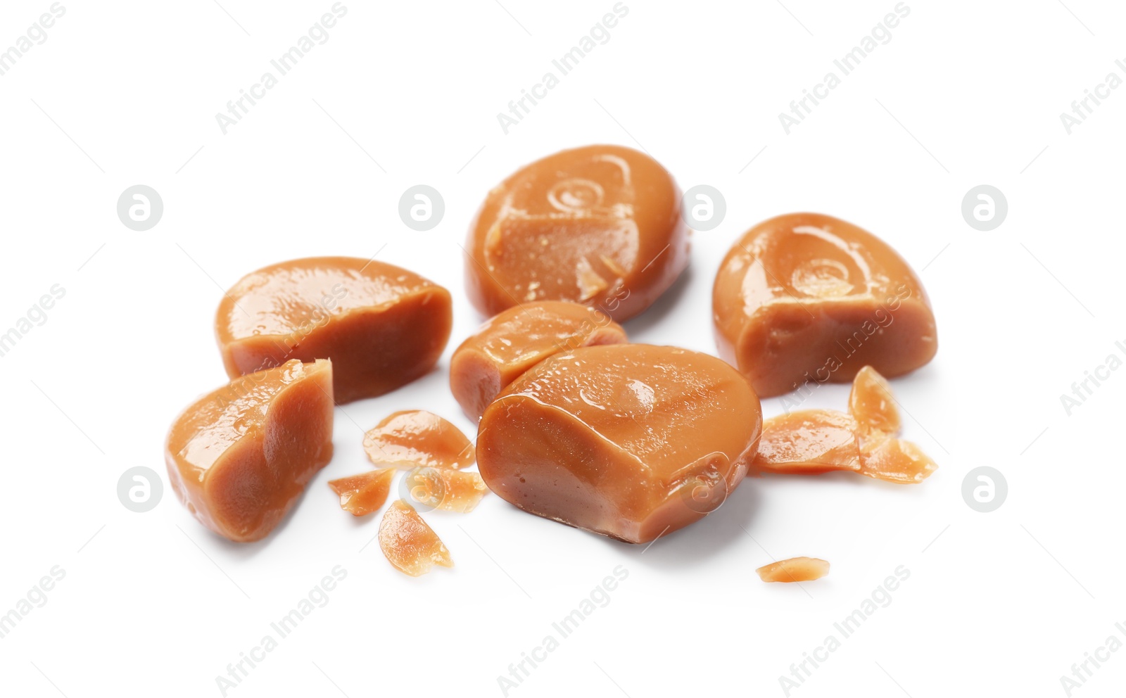 Broken tasty caramel candies isolated on white Photo of Broken tasty caramel candies isolated on white