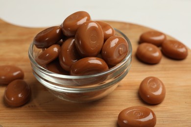 Photo of Many tasty caramel candies on white table, closeup