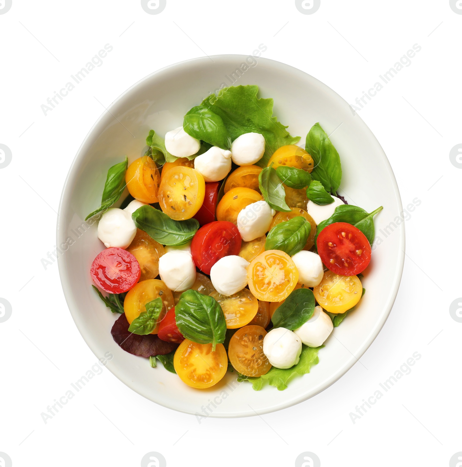 Tasty salad with yellow tomatoes, basil and mozzarella cheese isolated on white, top view Photo of Tasty salad with yellow tomatoes, basil and mozzarella cheese isolated on white, top view