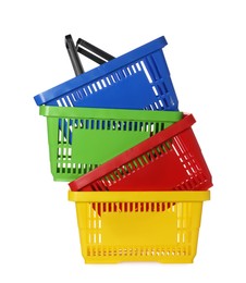 Photo of Stack of colorful shopping baskets isolated on white