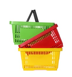 Photo of Stack of colorful shopping baskets isolated on white