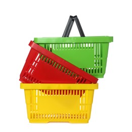 Photo of Stack of colorful shopping baskets isolated on white