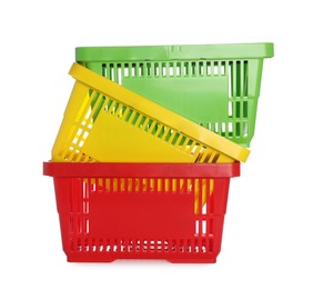 Photo of Stack of colorful shopping baskets isolated on white