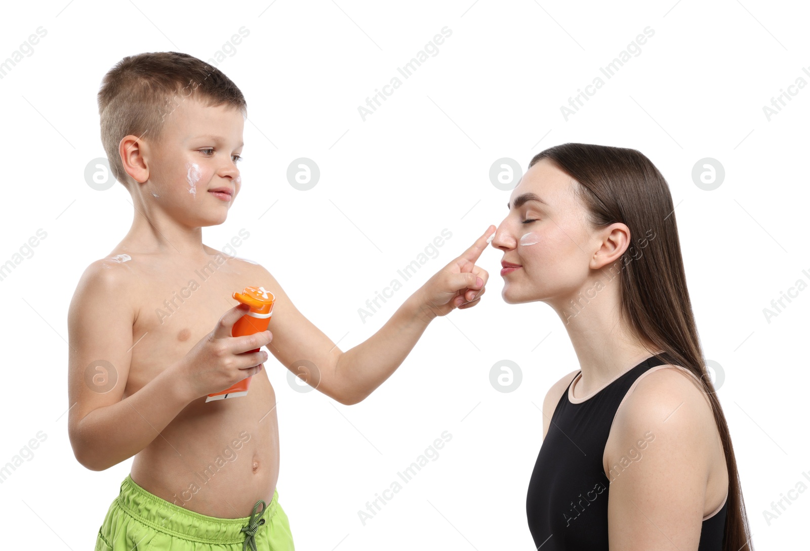 Son applying sun protection cream onto his mother's skin on white background Photo of Son applying sun protection cream onto his mother's skin on white background