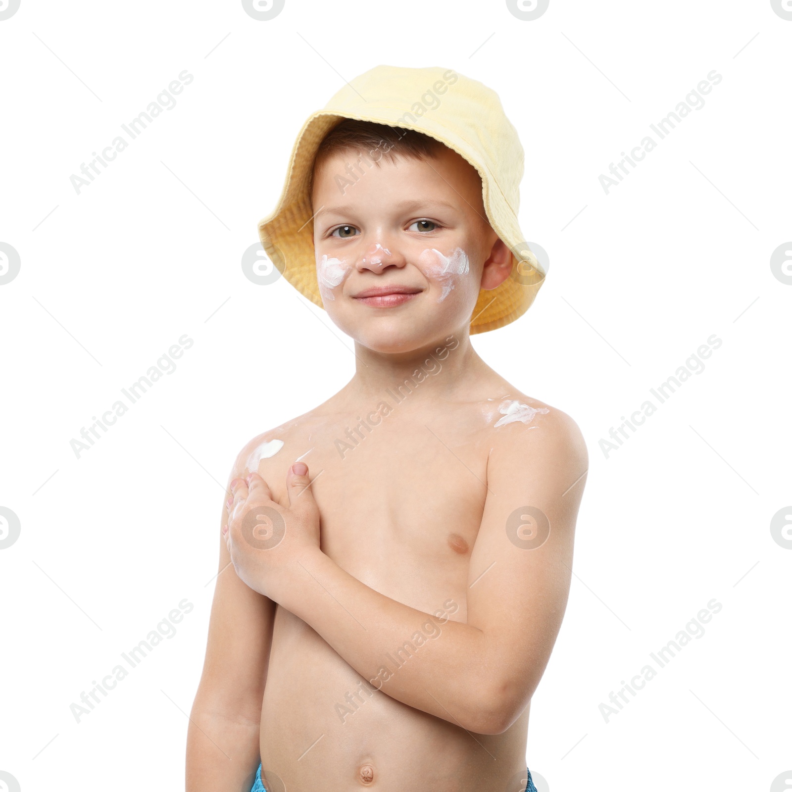 Photo of Little boy applying sun protection cream onto his skin on white background