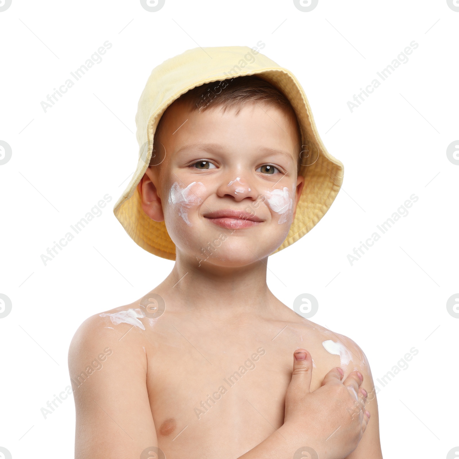 Photo of Little boy applying sun protection cream onto his skin on white background