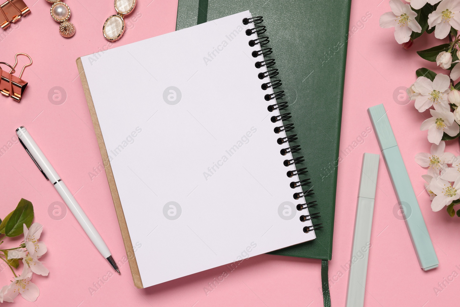 Planner and stationery on pink background, flat lay Photo of Planner and stationery on pink background, flat lay
