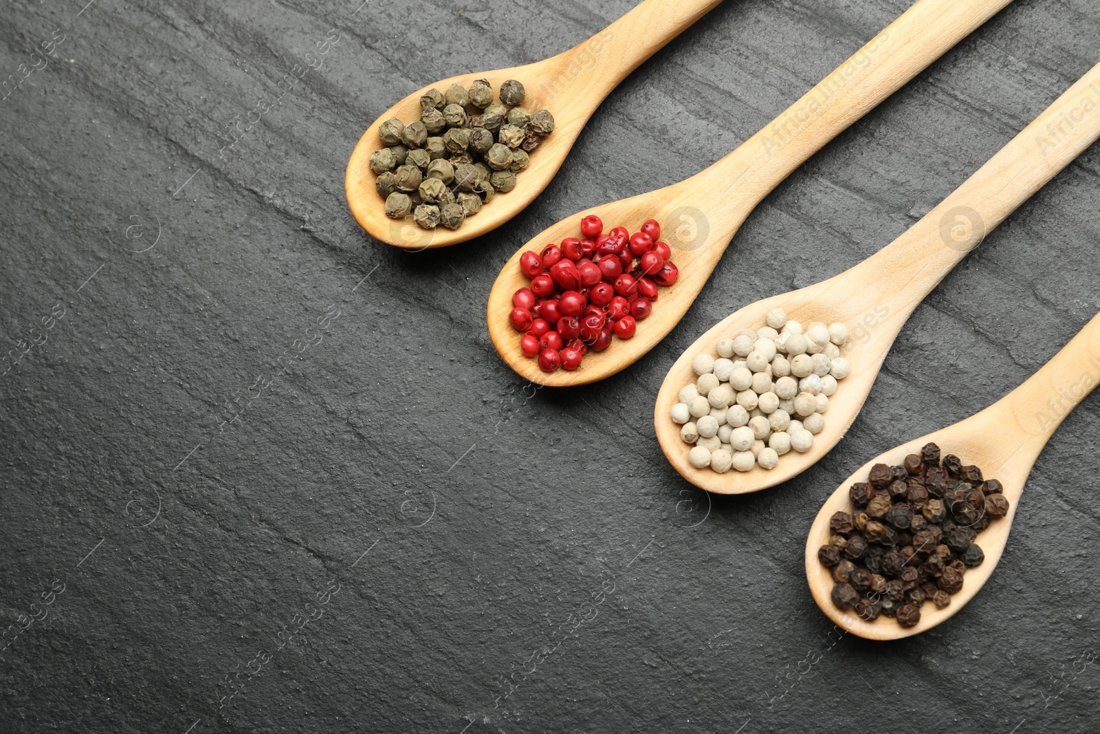 Different aromatic spices in spoons on black table, flat lay. Space for text Photo of Different aromatic spices in spoons on black table, flat lay. Space for text