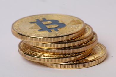 Photo of Cryptocurrency. Many golden bitcoins on white background, closeup