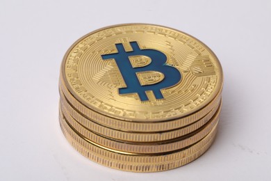 Photo of Cryptocurrency. Many golden bitcoins on white background, closeup