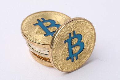 Photo of Cryptocurrency. Many golden bitcoins on white background, closeup