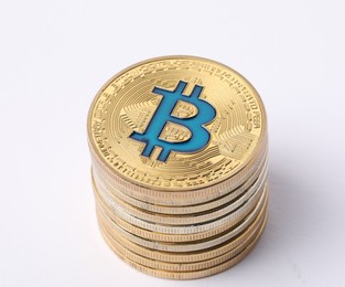 Photo of Cryptocurrency. Many golden bitcoins on white background, closeup