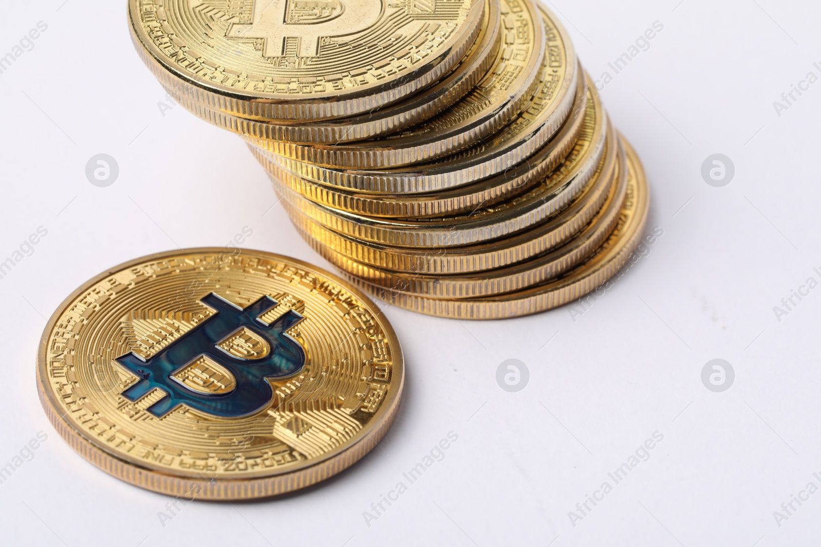Cryptocurrency. Many golden bitcoins on white background, closeup Photo of Cryptocurrency. Many golden bitcoins on white background, closeup