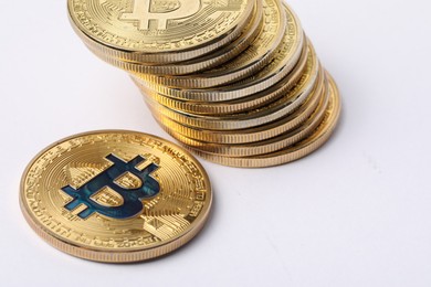 Photo of Cryptocurrency. Many golden bitcoins on white background, closeup