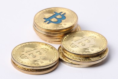 Photo of Cryptocurrency. Many golden bitcoins on white background, closeup