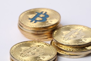 Photo of Cryptocurrency. Many golden bitcoins on white background, closeup