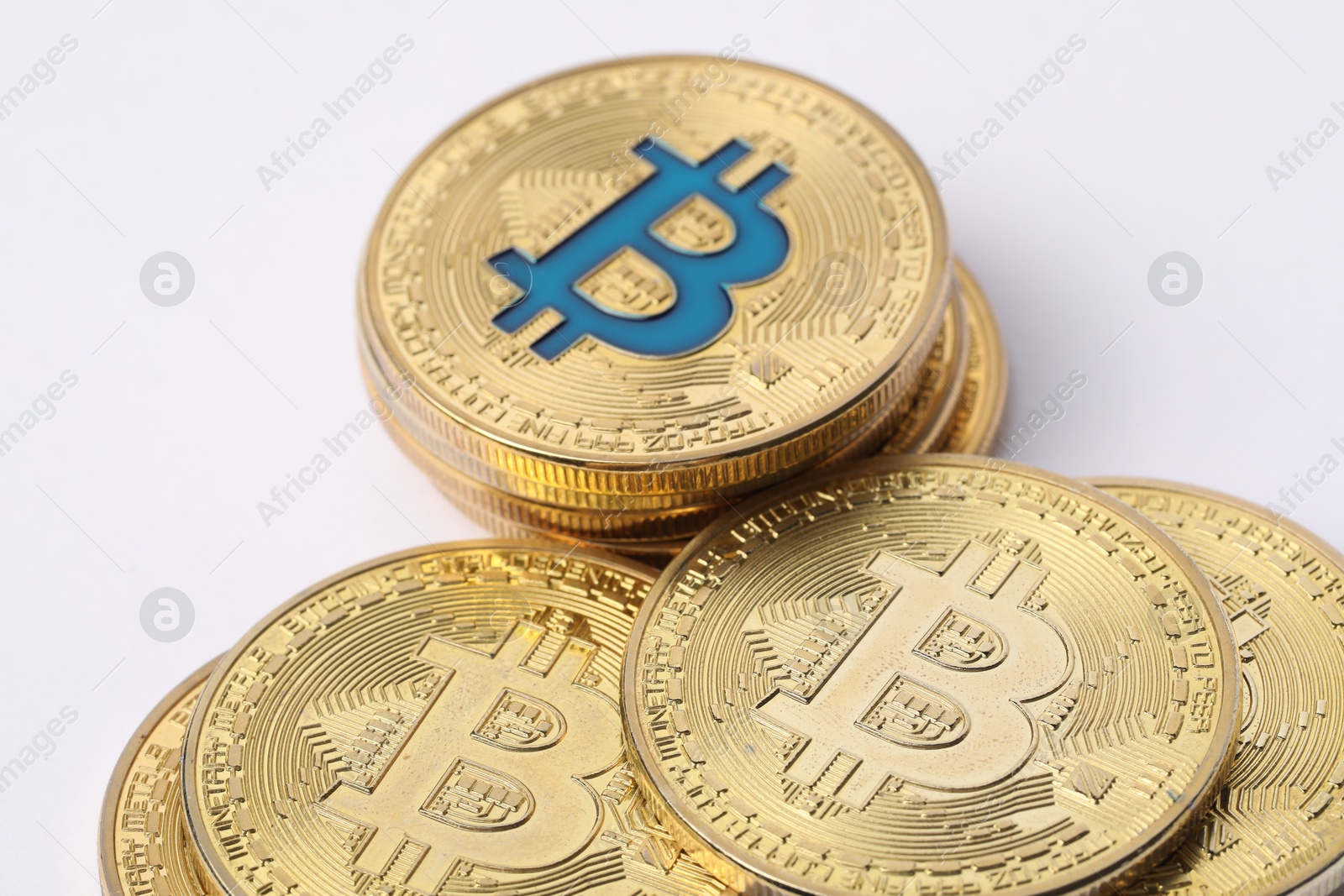 Cryptocurrency. Many golden bitcoins on white background, closeup Photo of Cryptocurrency. Many golden bitcoins on white background, closeup
