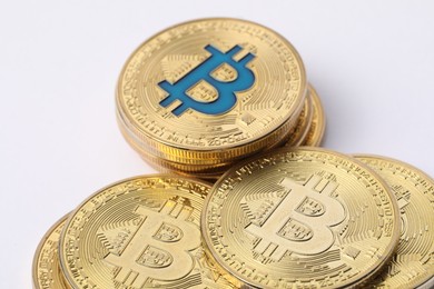 Photo of Cryptocurrency. Many golden bitcoins on white background, closeup