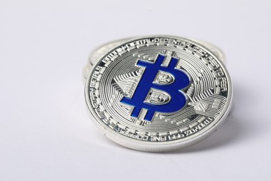 Photo of Cryptocurrency. Many silver bitcoins on white background, closeup