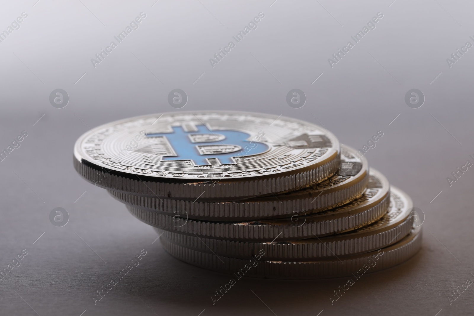 Cryptocurrency. Many silver bitcoins on light grey background, closeup Photo of Cryptocurrency. Many silver bitcoins on light grey background, closeup