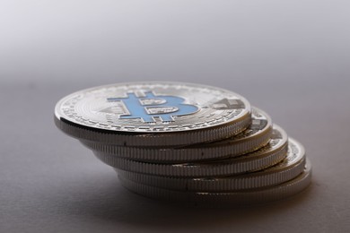 Photo of Cryptocurrency. Many silver bitcoins on light grey background, closeup