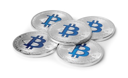 Photo of Cryptocurrency. Many silver bitcoins isolated on white