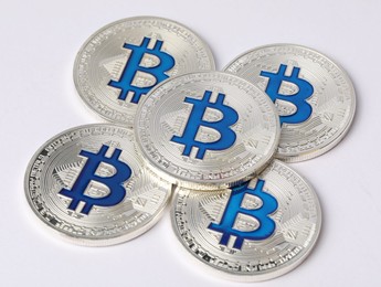 Photo of Cryptocurrency. Many silver bitcoins on white background, closeup