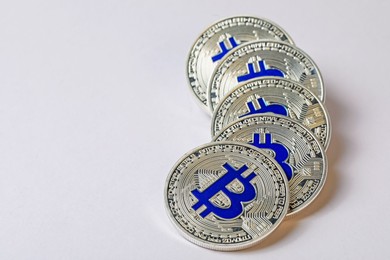Photo of Cryptocurrency. Many silver bitcoins on light background, closeup. Space for text