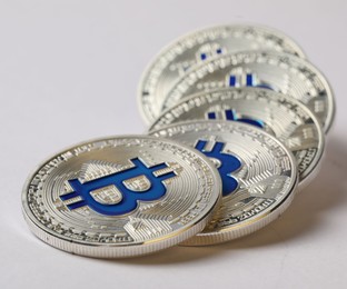 Photo of Cryptocurrency. Many silver bitcoins on light background, closeup