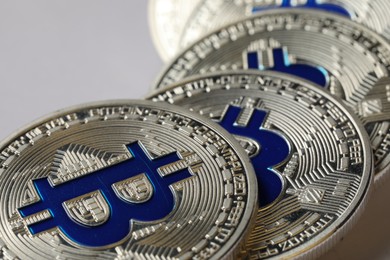 Photo of Cryptocurrency. Many silver bitcoins on light background, closeup