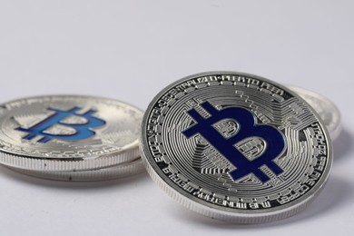 Photo of Cryptocurrency. Many silver bitcoins on light background, closeup