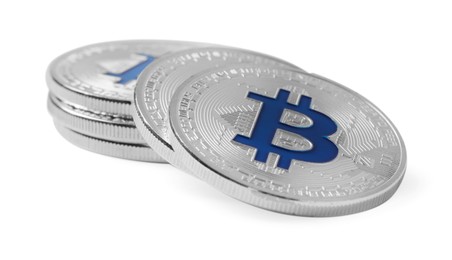 Photo of Cryptocurrency. Many silver bitcoins isolated on white