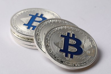 Photo of Cryptocurrency. Many silver bitcoins on light background, closeup