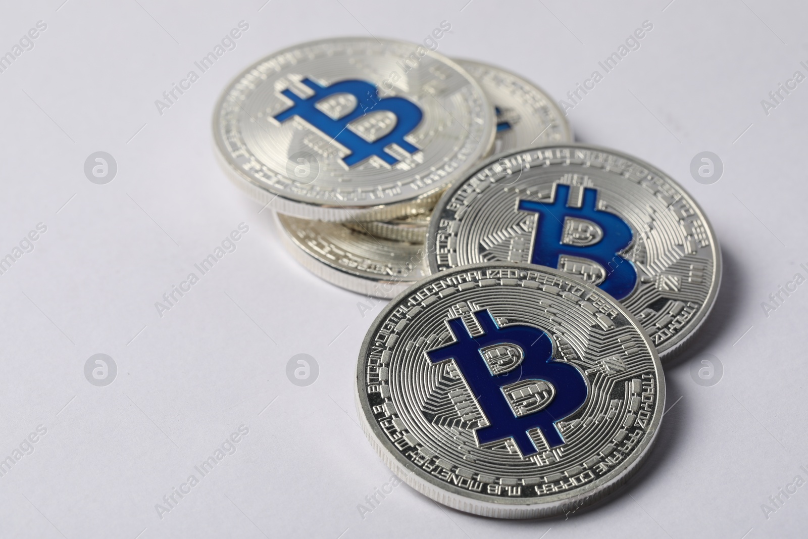 Cryptocurrency. Many silver bitcoins on light background, closeup Photo of Cryptocurrency. Many silver bitcoins on light background, closeup
