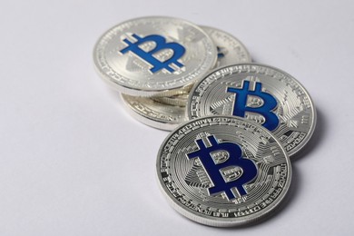 Photo of Cryptocurrency. Many silver bitcoins on light background, closeup