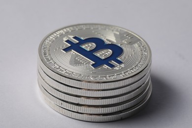 Photo of Cryptocurrency. Many silver bitcoins on light background, closeup