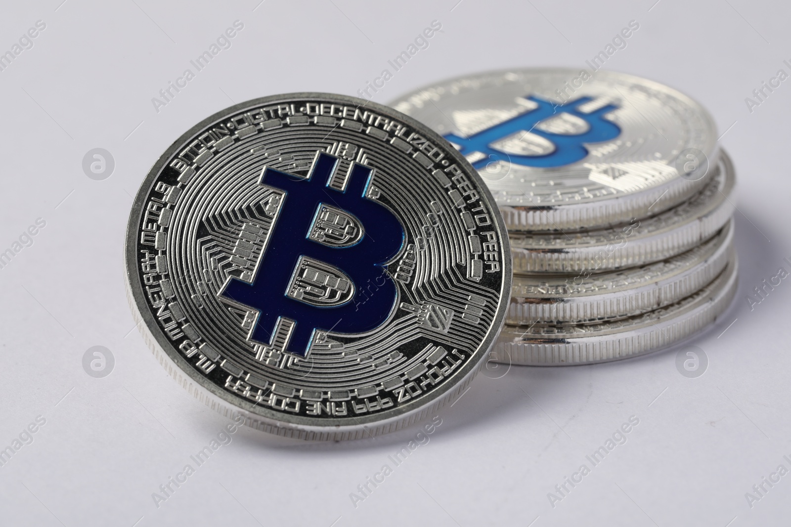 Cryptocurrency. Many silver bitcoins on light background, closeup Photo of Cryptocurrency. Many silver bitcoins on light background, closeup