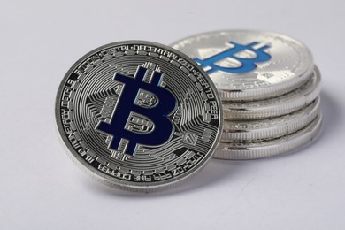 Photo of Cryptocurrency. Many silver bitcoins on light background, closeup