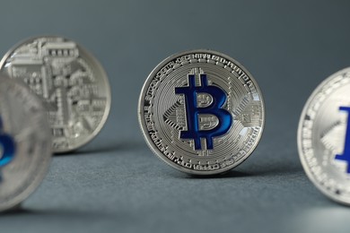 Photo of Cryptocurrency. Many bitcoins on grey background, closeup