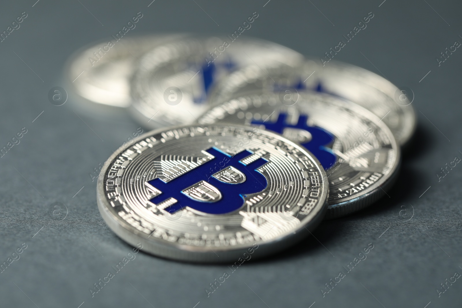 Cryptocurrency. Many bitcoins on grey background, closeup Photo of Cryptocurrency. Many bitcoins on grey background, closeup