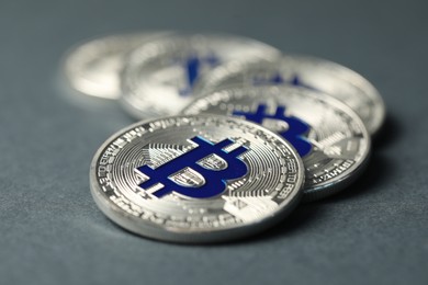 Photo of Cryptocurrency. Many bitcoins on grey background, closeup