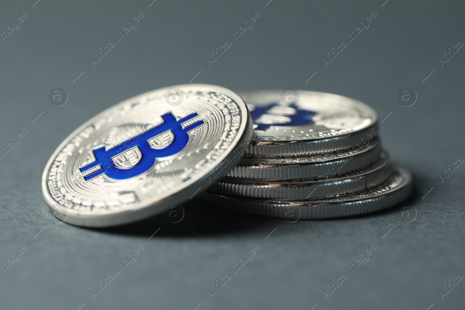 Cryptocurrency. Many bitcoins on grey background, closeup Photo of Cryptocurrency. Many bitcoins on grey background, closeup