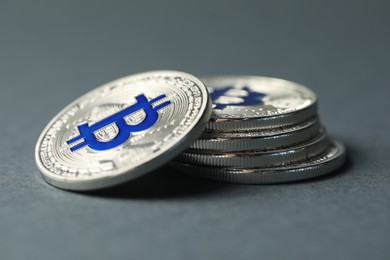 Photo of Cryptocurrency. Many bitcoins on grey background, closeup
